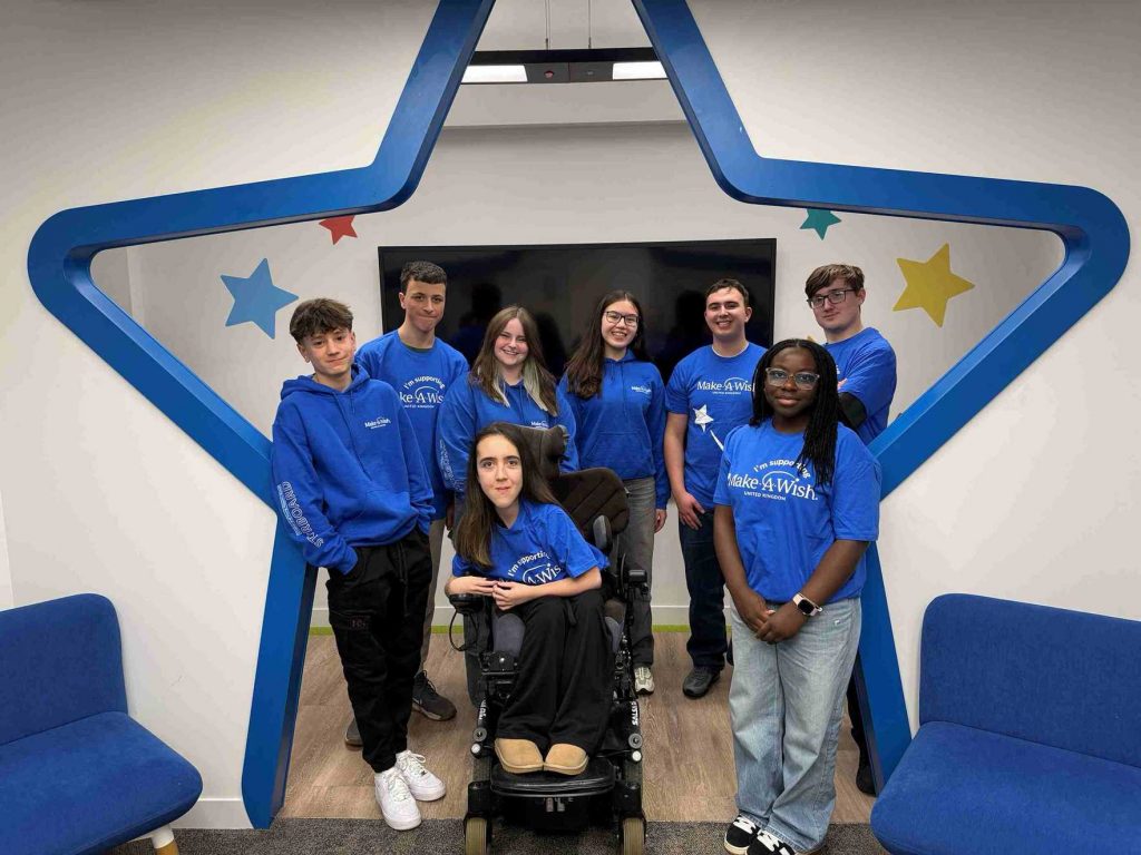 A Picture of Theo with the rest of the Make-A-Wish STARboard team inside the make a wish headquarters